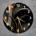 a black and gold clock on a gray wall